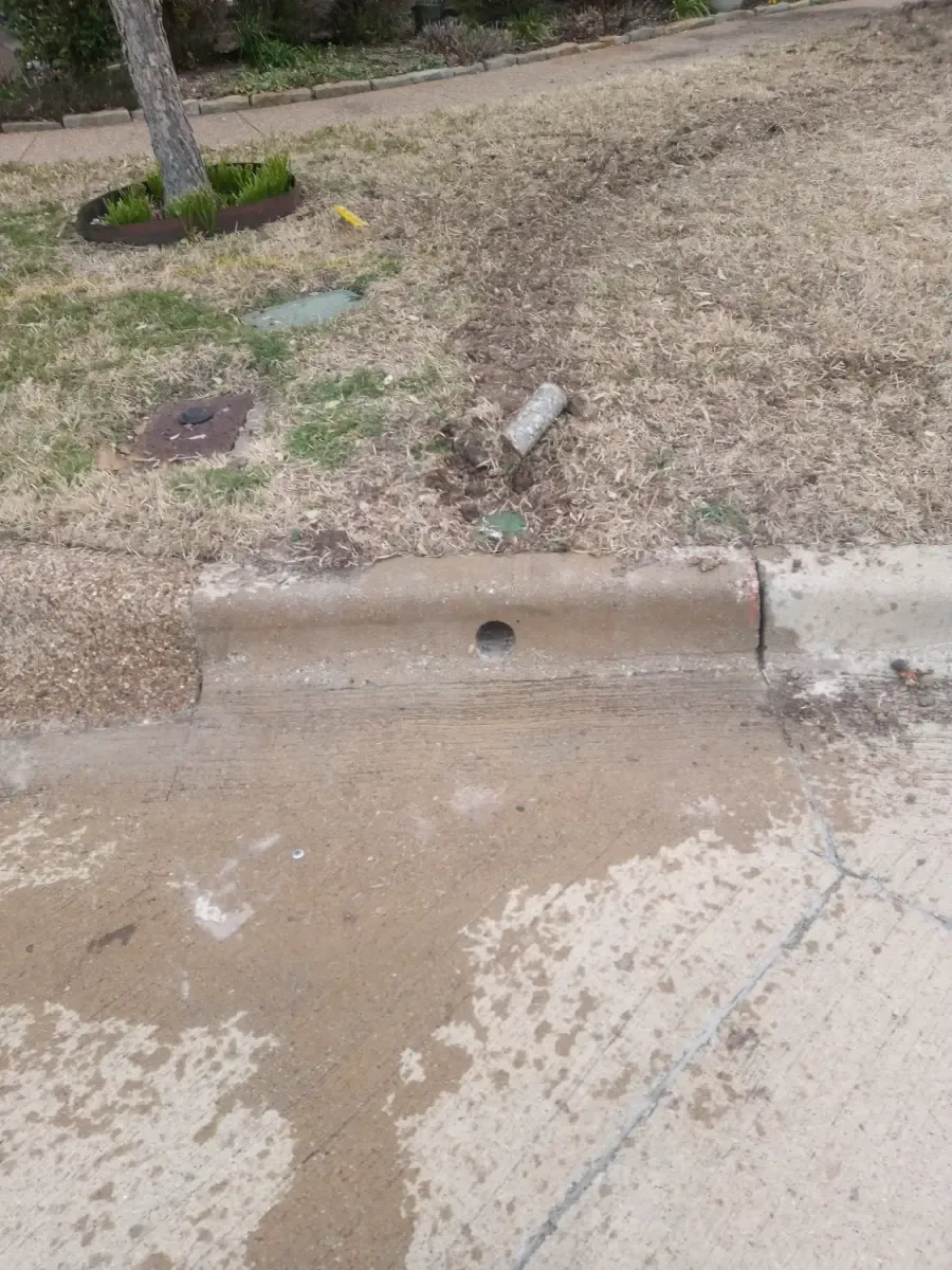Technician drilling deep core utility hole in vertical concrete wall