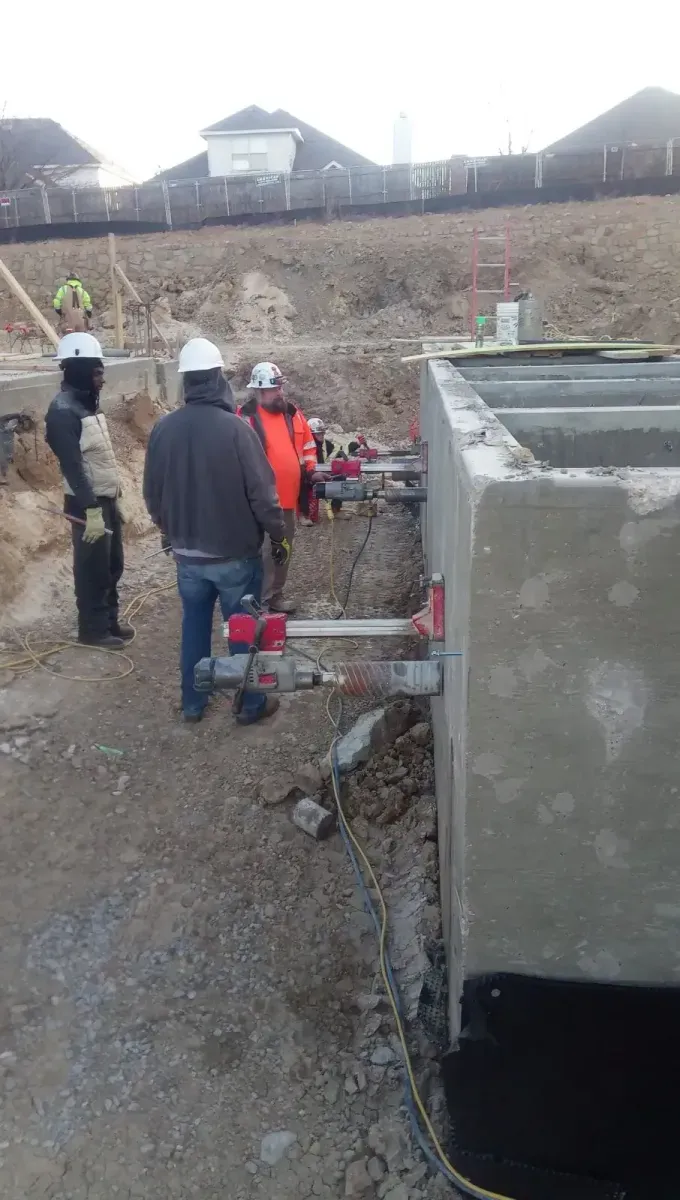 Active core drilling operator working on site with a heavy vertical rig