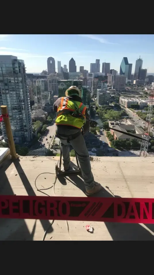 Concrete core drilling equipment anchored to a structural rooftop slab