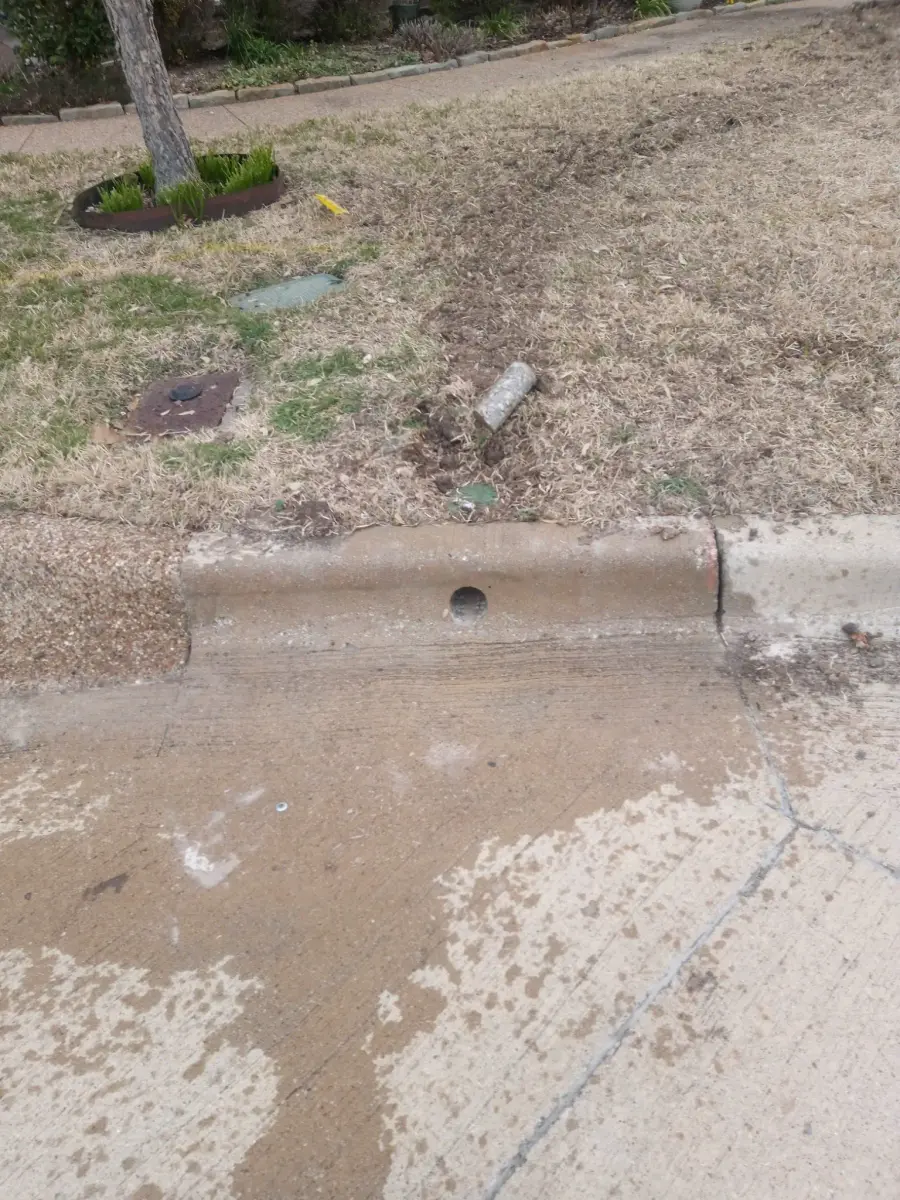 Technician drilling deep core utility hole in vertical concrete wall